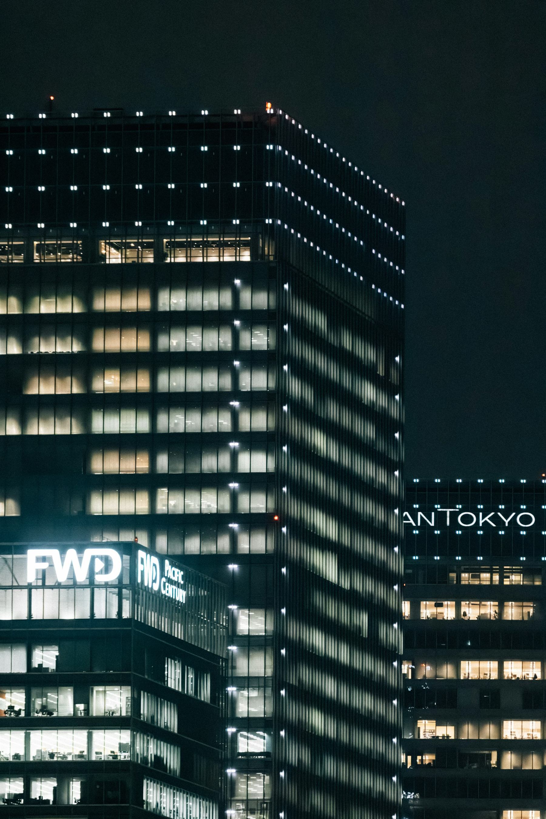 Tokyo office district at night — international real estate consultation